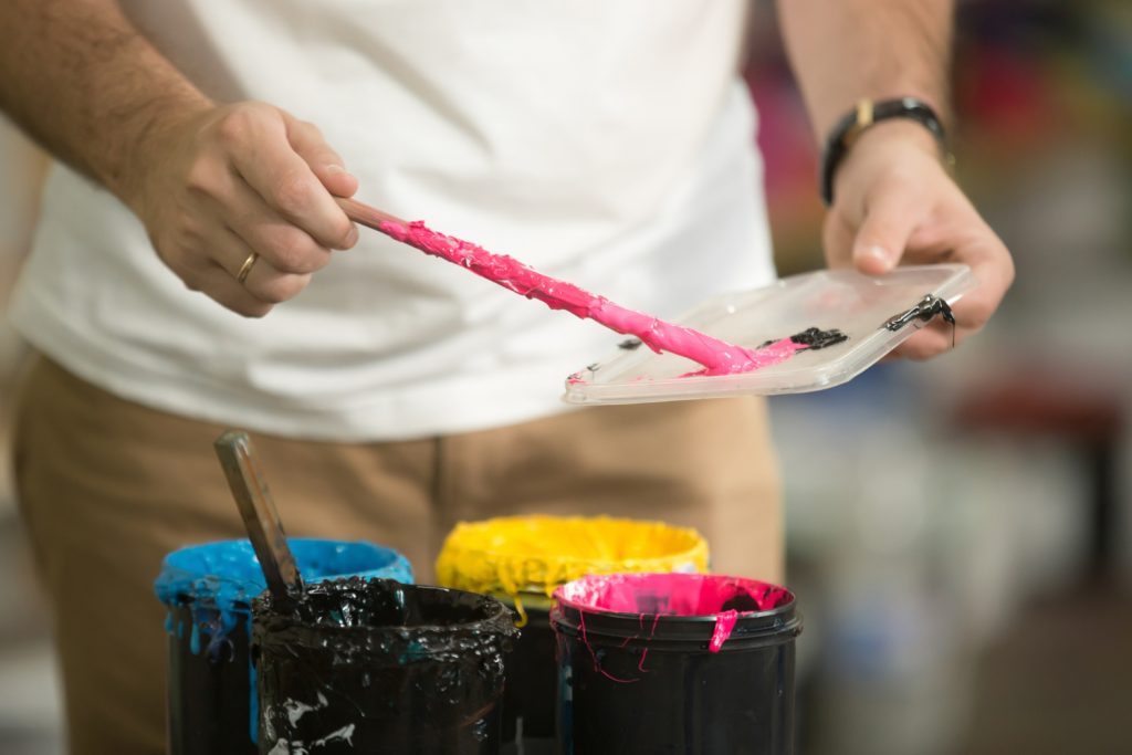 Close up of male hands combining CMYK
