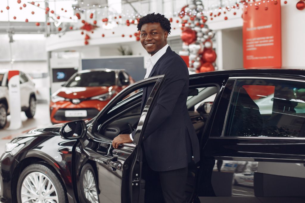 Handsome and elegant man in a car salon