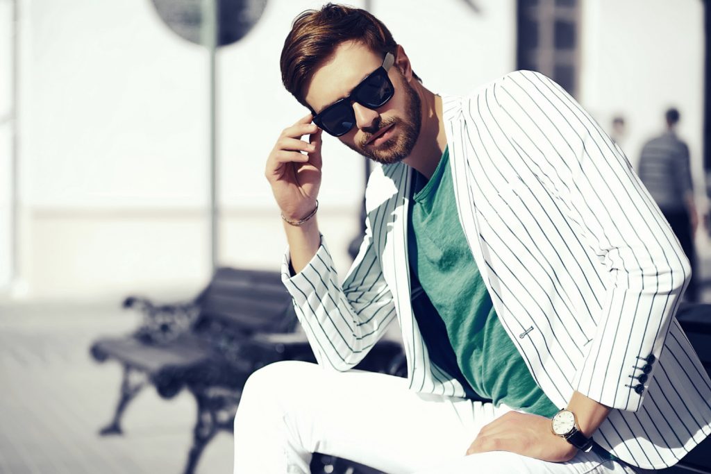 Young stylish confident happy handsome businessman model in suit cloth lifestyle in the street in sunglasses